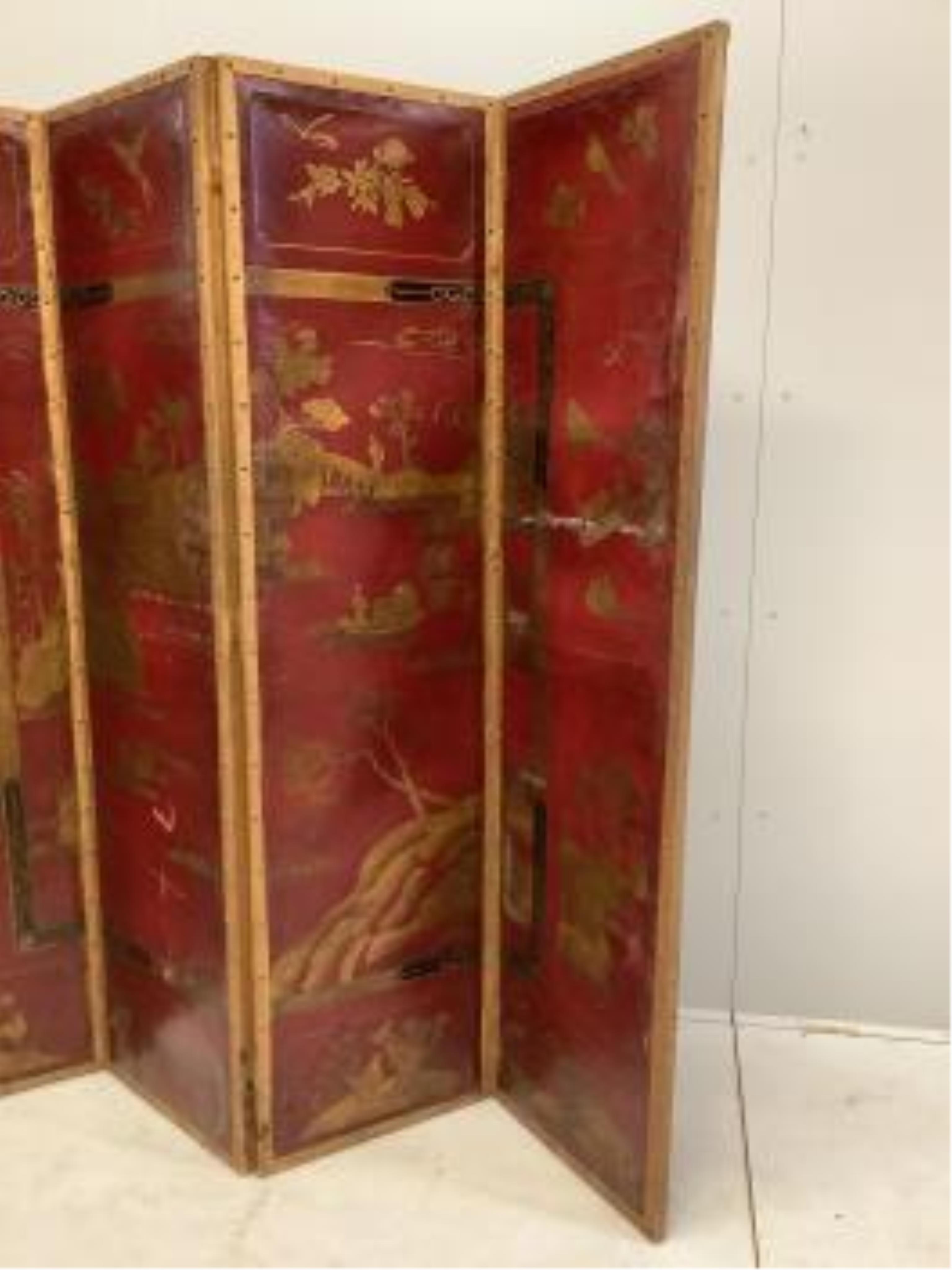 An early 20th century chinoiserie painted leather four fold screen, each panel width 46cm, height 180cm. Condition - poor to fair (two panels holed in three places, one with poor horizontal restoration)